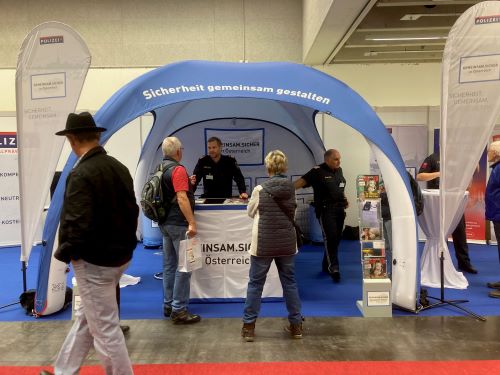 Besuchergespräche mit Polizisten beim Promotionzelt